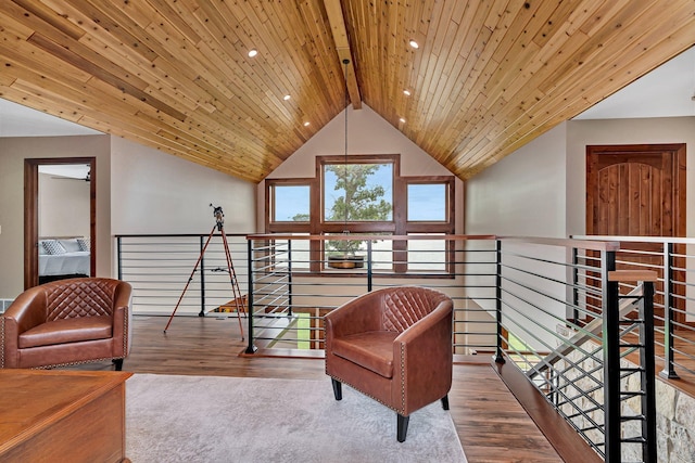 living area featuring lofted ceiling with beams, wood-type flooring, and wood ceiling