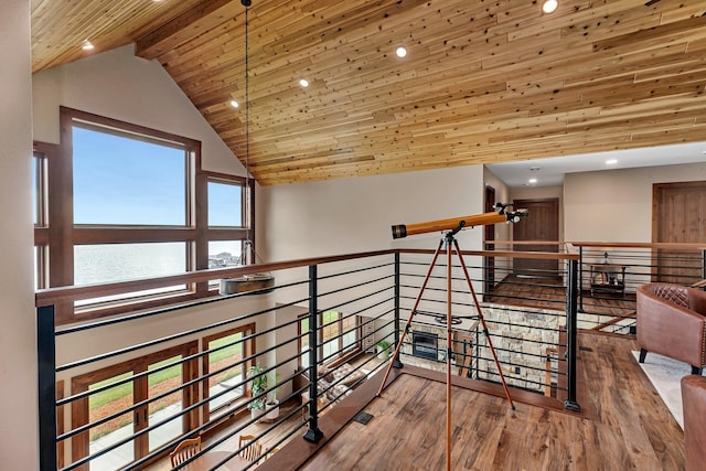 corridor featuring hardwood / wood-style floors, a water view, wood ceiling, and high vaulted ceiling