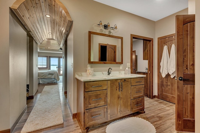 bathroom with vanity, wood ceiling, and hardwood / wood-style flooring