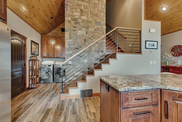 staircase with hardwood / wood-style floors, separate washer and dryer, high vaulted ceiling, and wooden ceiling