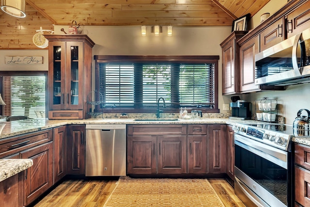 kitchen featuring light stone countertops, sink, wooden ceiling, lofted ceiling, and appliances with stainless steel finishes