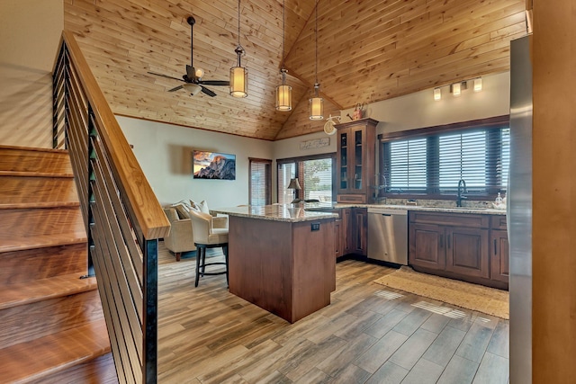 kitchen with high vaulted ceiling, appliances with stainless steel finishes, decorative light fixtures, light stone counters, and wood ceiling