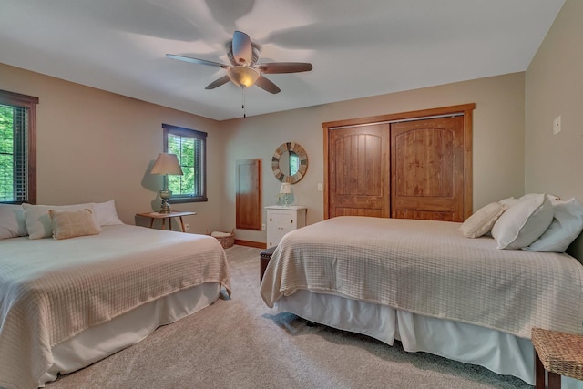 bedroom featuring ceiling fan, carpet floors, and a closet