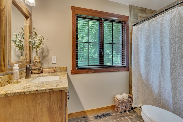 bathroom featuring vanity and toilet