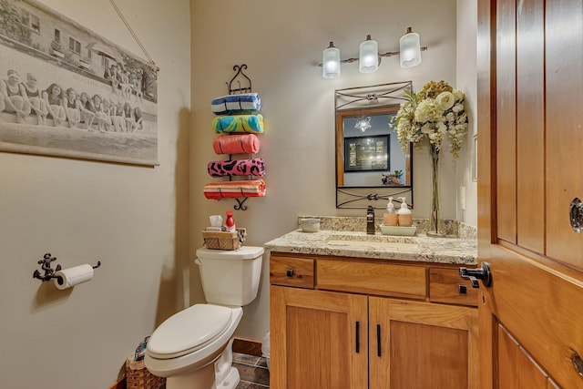 bathroom featuring tile patterned floors, vanity, and toilet