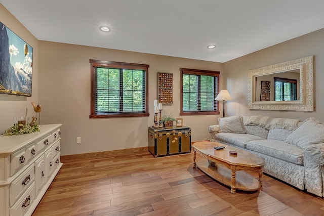 living area featuring plenty of natural light and light hardwood / wood-style flooring