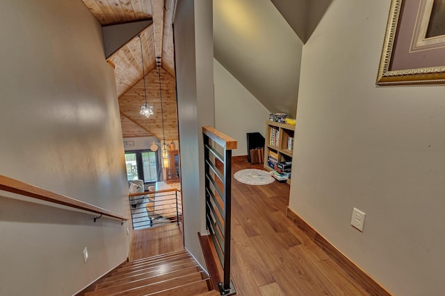 stairs featuring hardwood / wood-style floors, lofted ceiling, and wooden ceiling