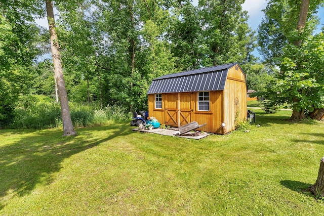 view of outbuilding featuring a lawn