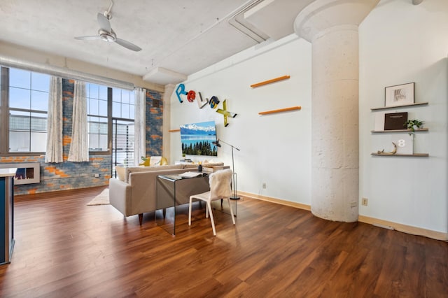 living room featuring wood finished floors, baseboards, and ceiling fan