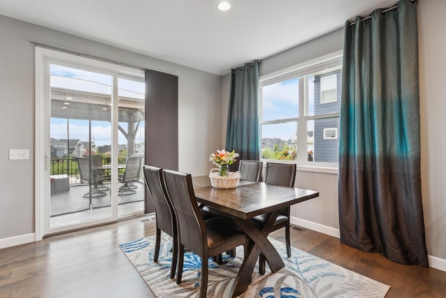 dining area with dark hardwood / wood-style flooring