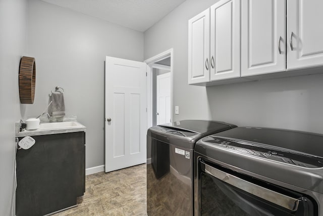 washroom featuring cabinets, separate washer and dryer, and sink