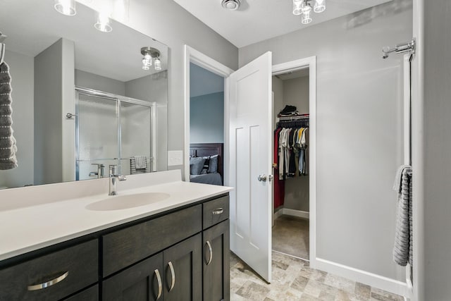 bathroom with vanity and a shower with shower door