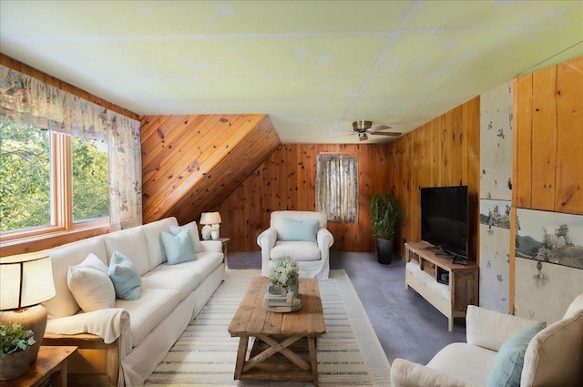 living room featuring carpet floors, wood walls, and ceiling fan