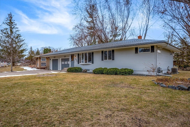 single story home with a front yard and a garage