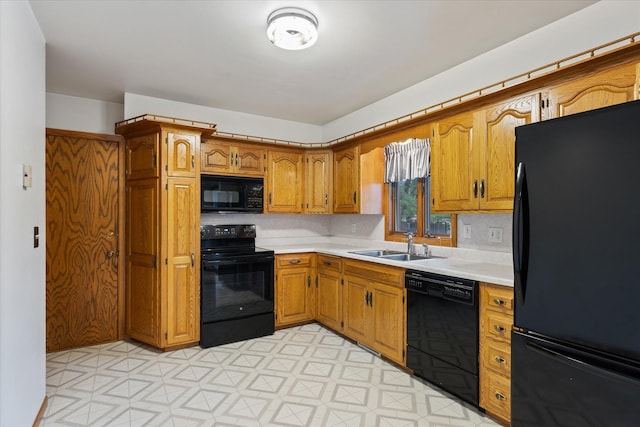 kitchen with sink and black appliances