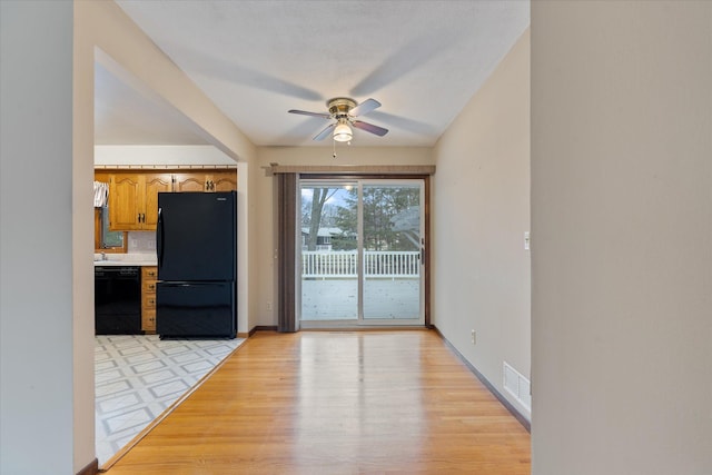 kitchen with black appliances, ceiling fan, light hardwood / wood-style flooring, and tasteful backsplash