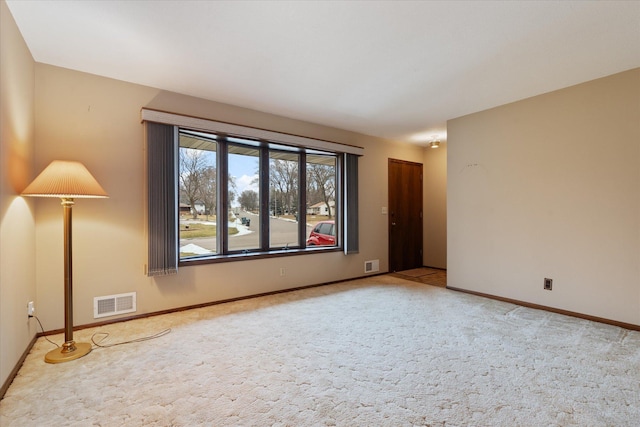 unfurnished room featuring light colored carpet