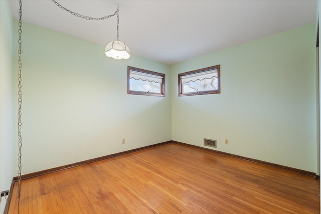 spare room featuring hardwood / wood-style floors