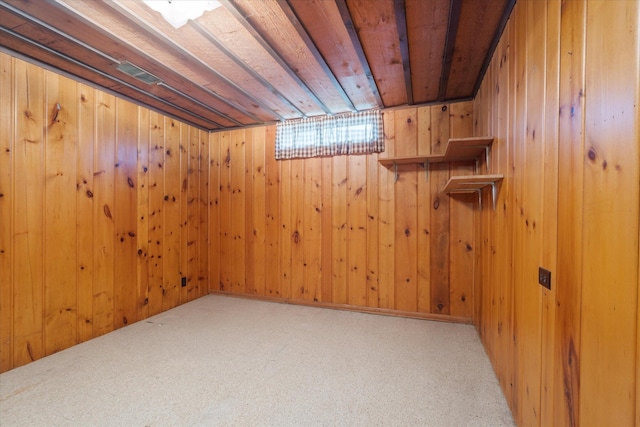 basement featuring carpet flooring, wood walls, and wooden ceiling