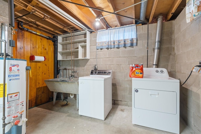 basement with washer and dryer, sink, and water heater