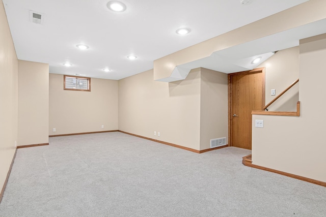 basement featuring light colored carpet