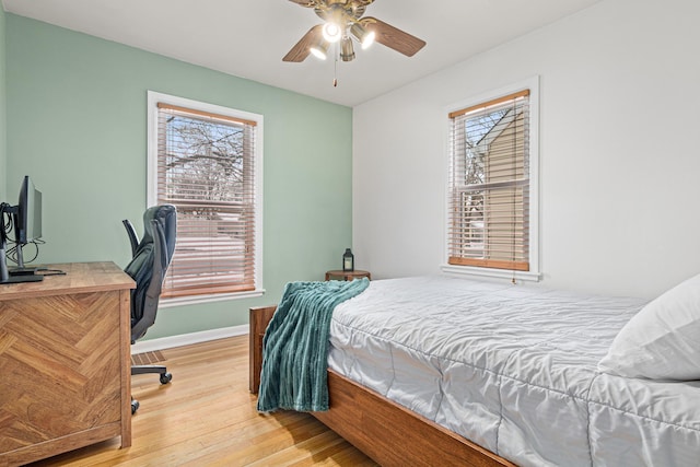 bedroom with hardwood / wood-style floors and ceiling fan