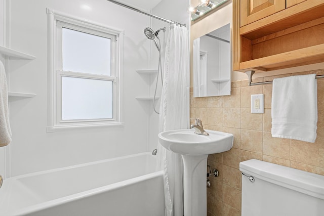 bathroom with shower / bath combo, tile walls, decorative backsplash, and toilet