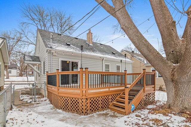 snow covered property featuring a wooden deck