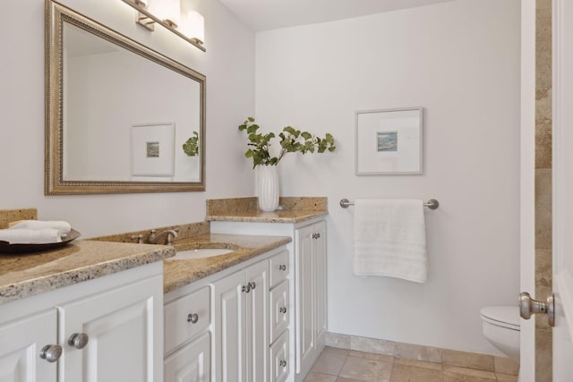 bathroom with toilet, tile patterned flooring, and vanity