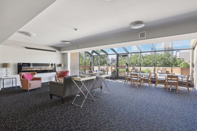 living area featuring visible vents, carpet flooring, and a sunroom