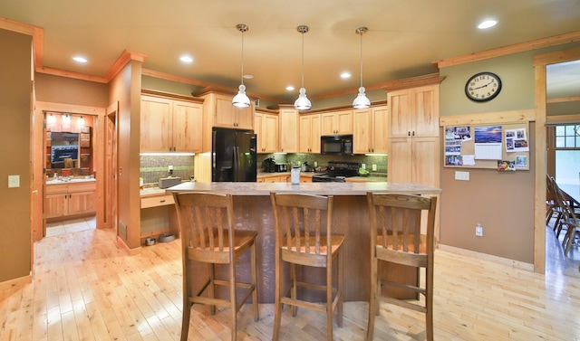 kitchen featuring light brown cabinetry, tasteful backsplash, crown molding, black appliances, and hanging light fixtures