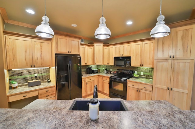 kitchen with hanging light fixtures, black appliances, and sink