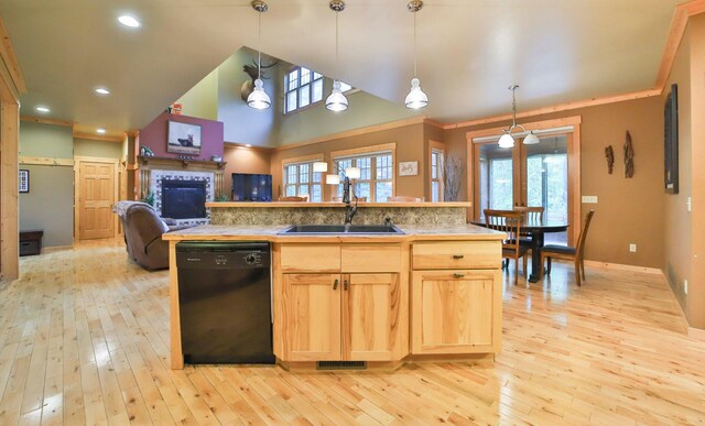 kitchen featuring light wood-type flooring, backsplash, sink, pendant lighting, and black dishwasher