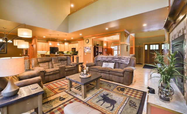 living room featuring hardwood / wood-style flooring and a towering ceiling