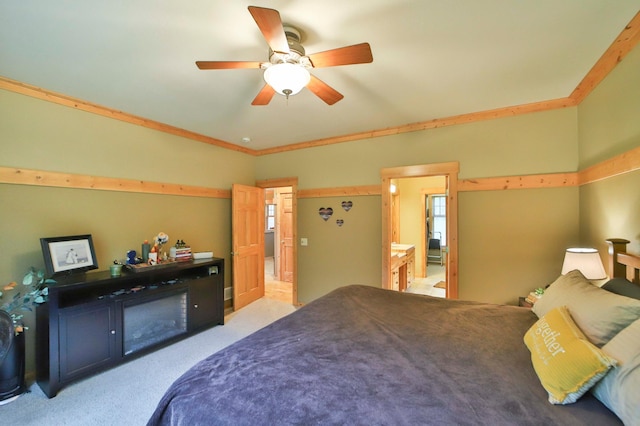 carpeted bedroom featuring a fireplace, ceiling fan, and ornamental molding