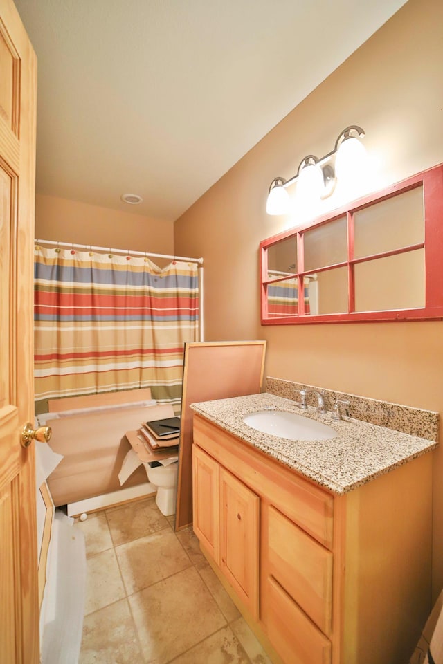 bathroom with tile patterned floors and vanity