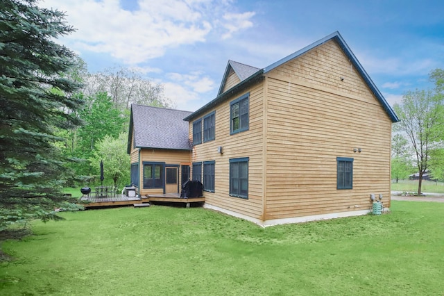 rear view of property with a lawn and a wooden deck