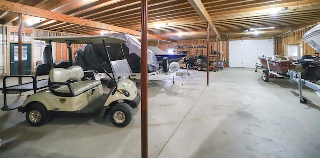 garage featuring a workshop area and a carport