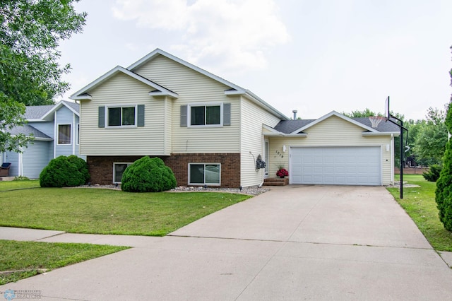 tri-level home featuring a front yard and a garage