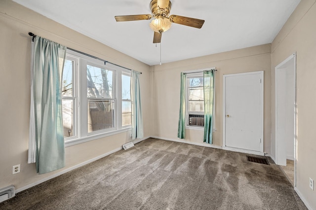 spare room featuring ceiling fan, carpet floors, and a baseboard radiator