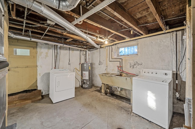 basement featuring washer and dryer, sink, and water heater