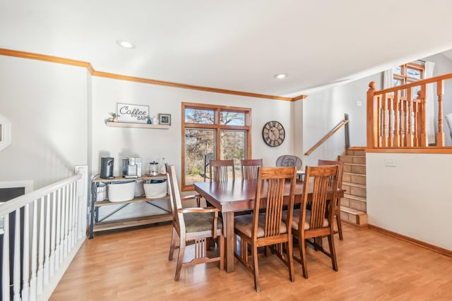 dining area featuring light hardwood / wood-style floors and ornamental molding