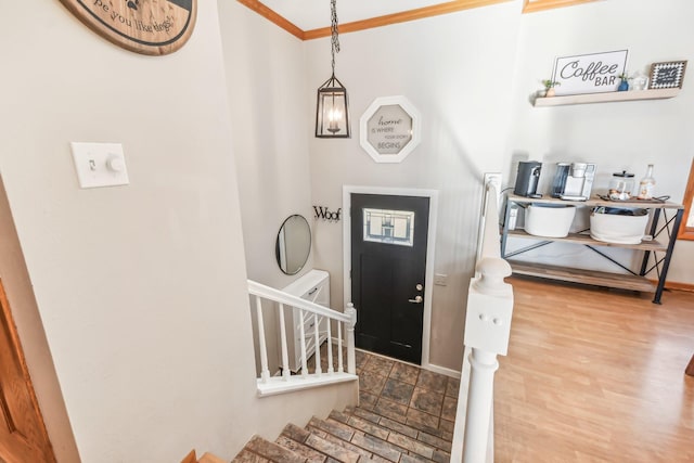 foyer featuring ornamental molding