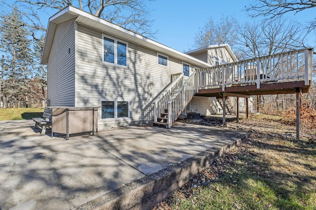 back of property with central AC, a patio area, and a wooden deck