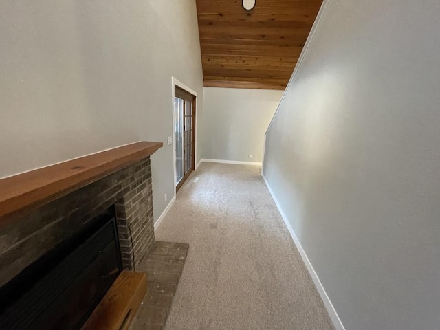 corridor with light colored carpet, wood ceiling, and lofted ceiling