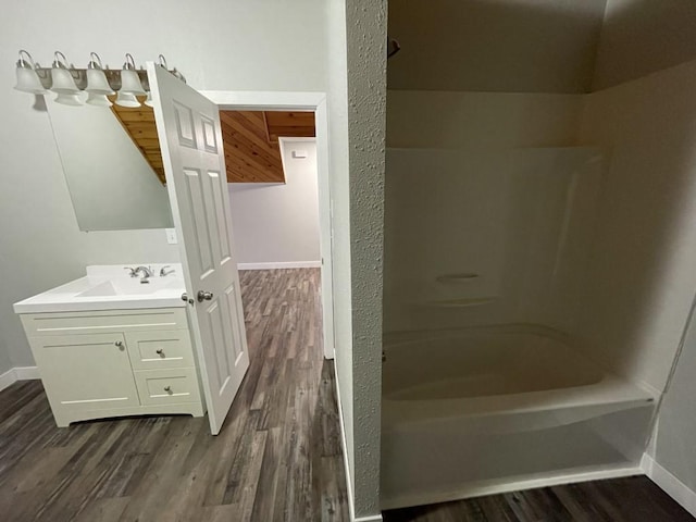 bathroom with shower / tub combination, vanity, and hardwood / wood-style flooring