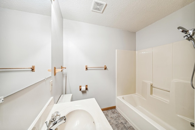 bathroom with sink, shower / tub combination, and a textured ceiling