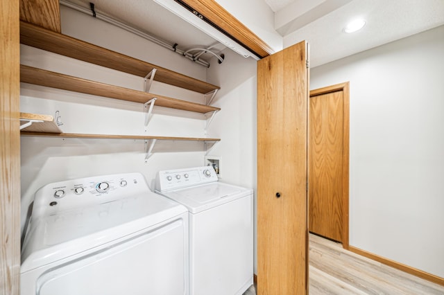 washroom featuring washer and dryer and light wood-type flooring