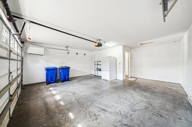 garage with white fridge and a garage door opener