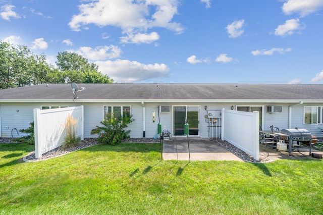 rear view of property featuring a yard and a patio